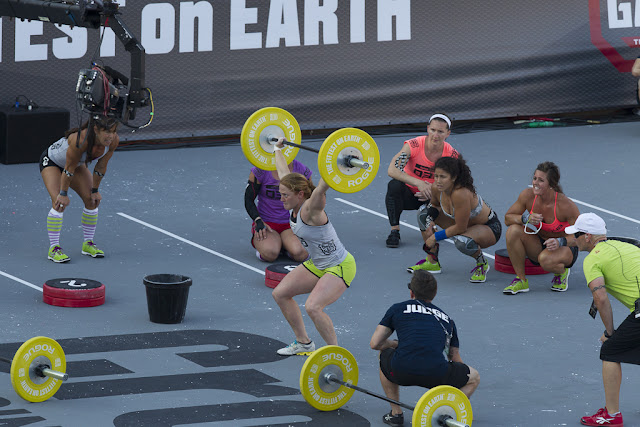 2012 CrossFit Games female competitors cheering an athlete on as she finishes her weight lifting movement