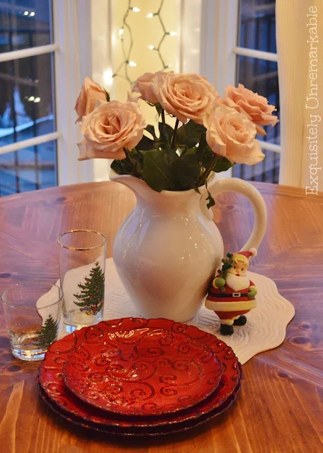 Christmas Table Setting With White Roses and Red Glass Dishes