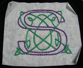Complete Celtic monogram S design with stabilizer still attached