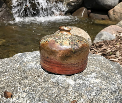 Thrown jug next to water