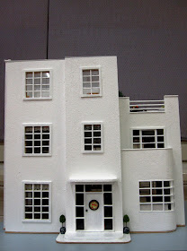 Front of an Art Deco moderne-style dolls house by Anne Reid