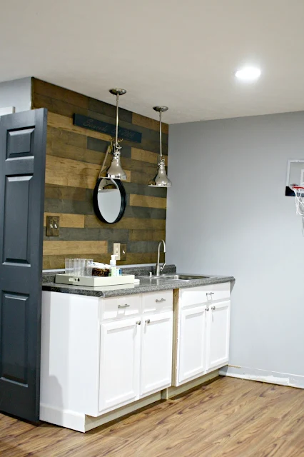 planked wood wall above cabinets