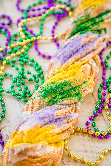 Easy King Cake Braid - perfect for Mardi Gras!!! Easy King Cake made with refrigerated french bread dough - stuffed with cream cheese, cinnamon and sugar. Topped with a quick powdered sugar and milk glaze and sprinkled with yellow, purple and green sugar. SO festive!!! Ready to eat in 30 minutes! Great for breakfast or dessert. I took this to a party and it was gone in a flash!!! YUM! #kingcake #mardigras Easy King Cake Braid - perfect for Mardi Gras!!! Easy King Cake made with refrigerated french bread dough - stuffed with cream cheese, cinnamon and sugar. Topped with a quick powdered sugar and milk glaze and sprinkled with yellow, purple and green sugar. SO festive!!! Ready to eat in 30 minutes! Great for breakfast or dessert. I took this to a party and it was gone in a flash!!! YUM! #kingcake #mardigras