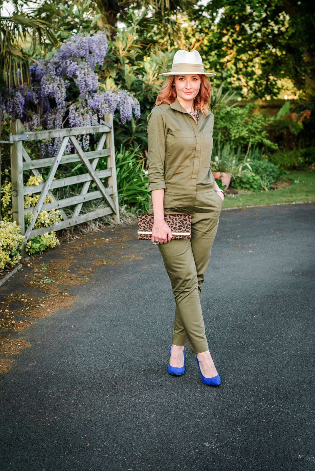 What to wear with a safari-style khaki jumpsuit: Cream fedora statement crystal necklace cobalt blue heels leopard clutch | Not Dressed As Lamb, over 40 style