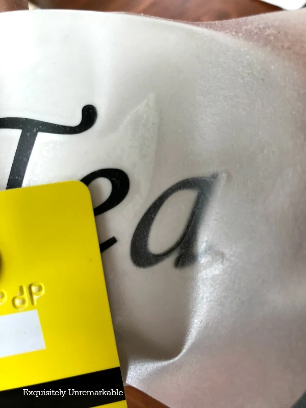 Applying A Vinyl Transfer On A Tea Cup with a credit card