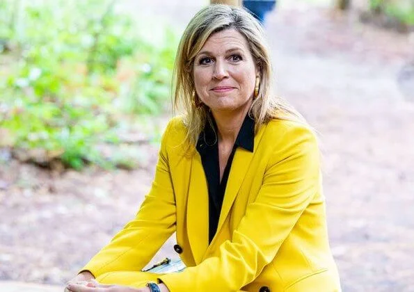 Queen Maxima wore a yellow blazer and trousers from Zara, Cartier gold bamboo earrings, carries Susan Gail bamboo handle handbag