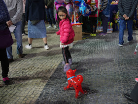 girl pulling inflatable dog on wheels