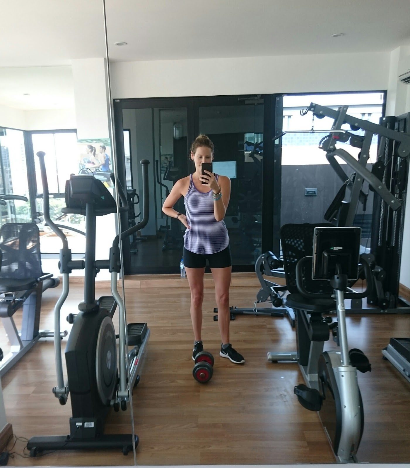 Travel blogger and digital nomad, Alison Hutchinson, is working out in the gym at the Nimman Palm Springs in Chiang Mai