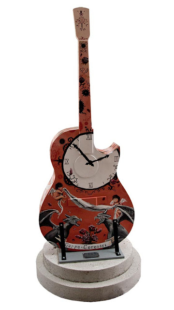 Orillia downtown, painted guitar displays, deep red guitar with painted clock and angels design