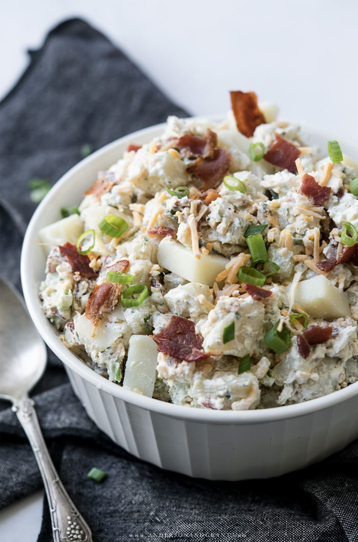 White dish of potato salad with bacon