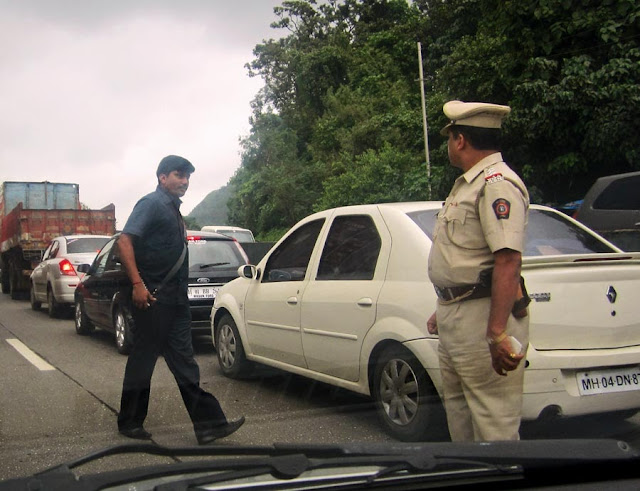 policemen in khaki helping politicians clear traffic jams