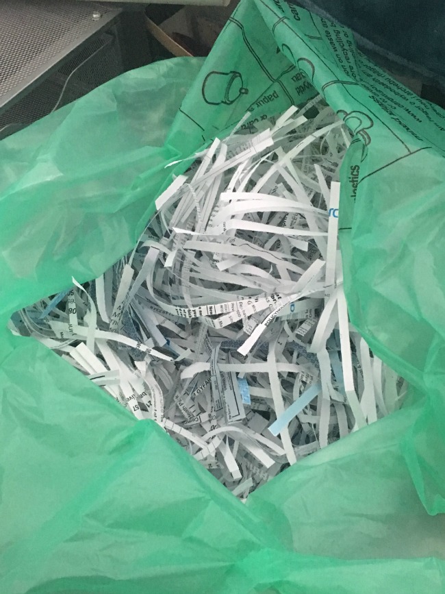 a-green-bag-of-shredded-paper