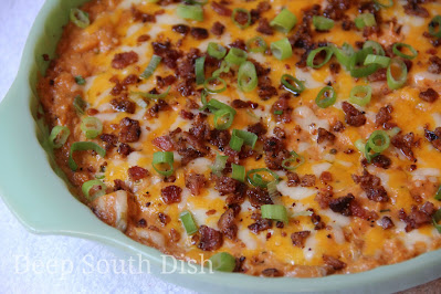 A crowd-pleasing combination of chicken in a cream cheese, mayonnaise and barbecue sauce base. Seasoned with dry Ranch dressing, a little extra onion and garlic powder, shredded cheese and finished with green onion and crumbled bacon. Perfect for tailgating - yum!
