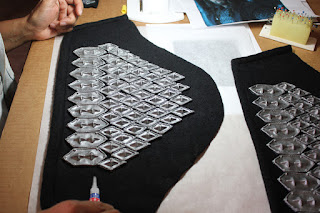 Gluing the scales on Thorin's sleeves.