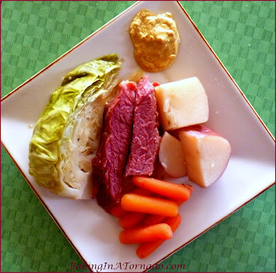 Crockpot Beer-Infused NE Boiled Dinner, for St. Patrick's Day or any day. Brown sugar rubbed corned beef, baby carrots, new potatoes and cabbage slow cooked in beer. | Recipe developed by www.BakingInATornado.com | #dinner #Crockpot #StPatricksDay