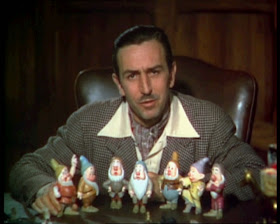 Walt Disney posing with 7 dwarfs animatedfilmreviews.filminspector.com