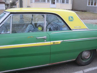 Green car with a yellow hardtop and yellow side stripe, plus John Deere logo