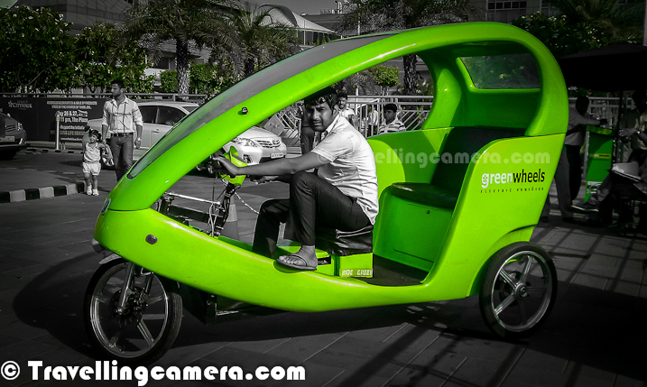 Recently Delhi's Chief Minister Sheila Dixit launched Green-Wheel Service at Saket. This is about running eco-friendly, battery powered & pollution free vehicles. Last weekend, I was at Select City Walk Mall of Saket and opted for Green-Wheel to reach Malviya Nagar Metro Station. Let's go through this Photo JOurney and know more about this lovely ride...As of now these are only launched in Saket and they run between Saket Malls & Malviya Nagar Metro Station. These Green-Wheels can be seen parked outisde Malviya Nagar Metro Station and Select City Walk Mall in Saket. They charge 20 Rs for one side and two people can sit at one point of time. Which means 10 rs per person, which is quite reasonable. Plan is to expand this service in other metro stations soon. Commuting from Malviya Nagar Metro to Saket Malls was one of the tedious thing. In fact, some time back when I went to Select City Walk via metro, I was surprised to know that Malviya Nagar Metro station is near as compared to Saket Station. Even the distance between Malviya Nagar and Saket malls is huge. So local transportation was one of the main pain point for folks commuting through Metro. G-Rik has solved this problem and hope that G-rik reach to other parts of Indian National Capital Region.These three-wheeler G-Riks were developed after extensive research and development by Green Wheels for over two years and has been fully customized to adapt to Indian conditions. Incidentally, Star Bus is the concessionaire for the first bus cluster launched in May 2011. At present, Delhi Metro runs feeder service as well on certain routes. This is besides the para-transit options like Gramin Sewa and autorickshaws. For more around this news, check out - http://articles.timesofindia.indiatimes.com/2012-04-28/delhi/31451728_1_bus-cluster-feeder-service-star-busThis photograph of Select City Walk Mall is clicked from G-Rik stand. It's located just at the exit of Parking. There is a counter on the corner from where one needs to take ticket for G-Rik ride. It takes around 7 minutes to reach Malviya Nagar Metro Station from Saket Malls. It seems that plan is to have around 5000 G-Riks in Delhi during next 15 months, which needs investment of around 100 crores.