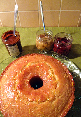 Whole Lemon Cake with Jars of Yellow and Red Raspberries, and Chocolate sauce