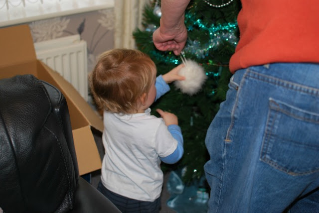 toddler taking a bauble from an adult