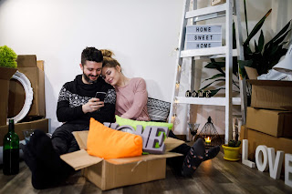 First time buyer couple looking at smart phone