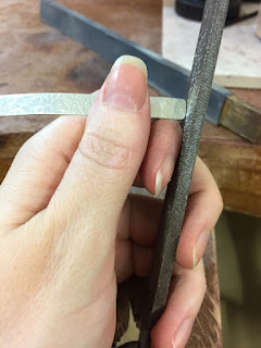 Filing the end of a flat silver ring