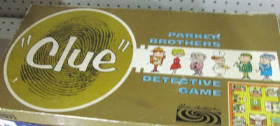 1960s Clue box, gold with huge magnifying glass and thumbprint