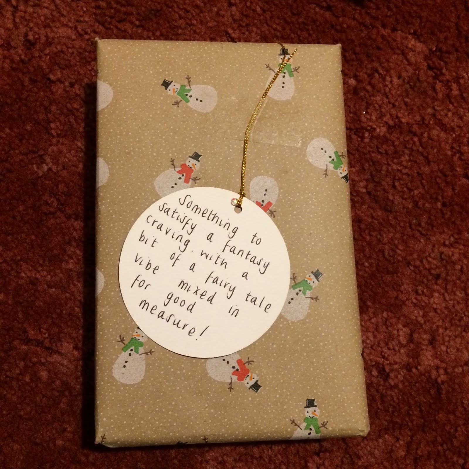 Wrapped present with a tag reading, Something to satisfy a fantasy craving with a bit of a fairy tale vibe mixed in for good measure!