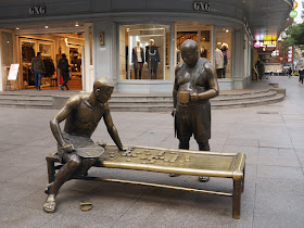 Sculpture of a xiangqi game with one man playing and another watching