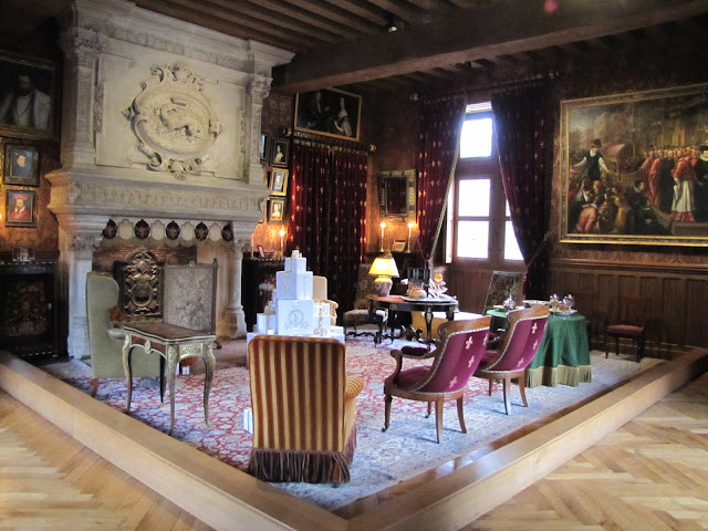 The salon at Chateau Azay-le-Rideau set out for Christmas with parcels in front of the fireplace