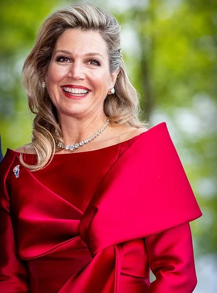 Queen Maxima wore a red top and red trousers. by Natan.Sarah's clutch bag. Carré Royal Theatre and around Amstel River