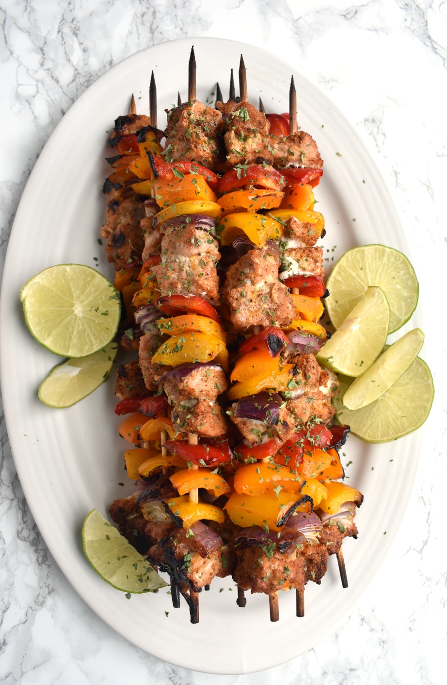 Pork Fajita Kebabs are ready in 30 minutes, are full of fajita flavors and are nutritious with marinated fajita lime pork, colorful bell peppers and onions! www.nutritionistreviews.com #grill #grilling #fajitas #mexican #mexicanfood #cincodemayo #pork #peppers platter of pork fajita kebabs