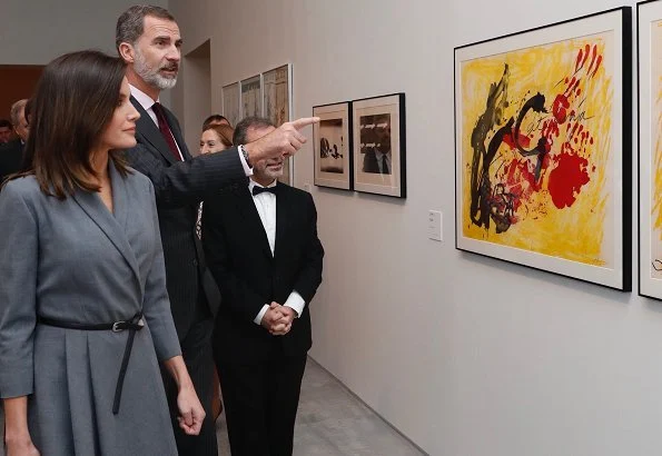 Queen Letizia wore Massimo Dutti tie dress, and Prada pumps, she carried Hugo Boss bespoke leather handbag