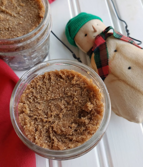 Exfoliating your skin never smelled so good! This DIY sugar scrub recipe is easy to make and is a perfect homemade gift too! jars of brown sugar scrub next to small snowman