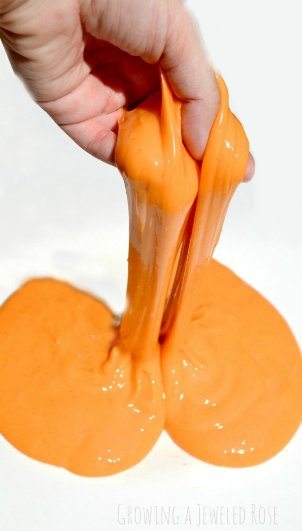 DIY Pumpkin SLIME- so fun for kids to stretch, pull, & squish! My kids couldn't stop giggling!