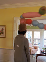 reindeer dress up game, back of woman with head of pantyhose filled with balloons