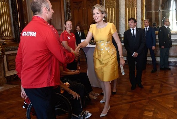 Queen Mathilde held a reception at the Royal Palace to congratulate the athletes that won medals. Mathilde wore a yellow dress by Natan fashion hause