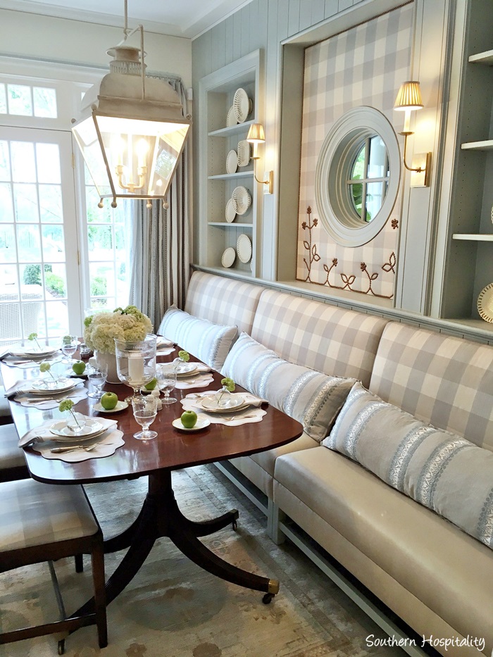 Blue and white check banquette in breakfast area with built-in shelves