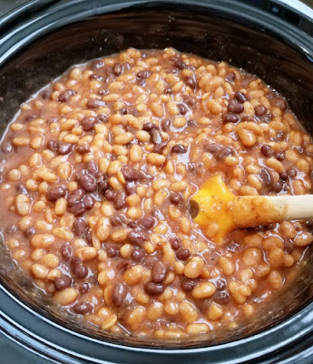 Serve up meaty delicious cowboy beans at your next bbq. They are a hearty and easy to make side dish that is made right in your slow cooker! slow cooker full of thick bean mixture