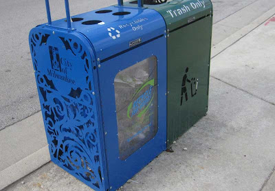 Side of the blue recycling container with scroll-work cutaways