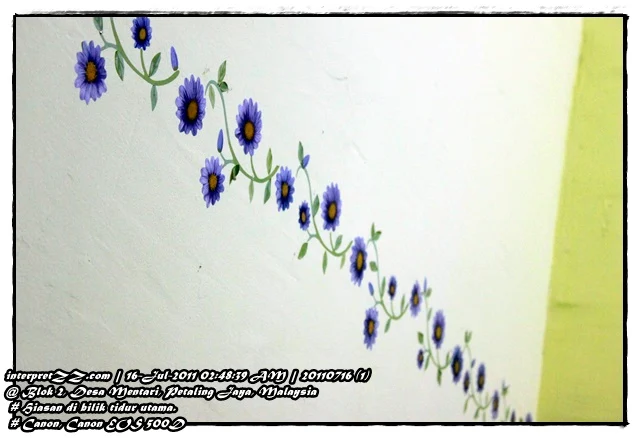 Gambar tampalan bercorak bunga ditampal di dinding bilik tidur utama Desa Mentari.