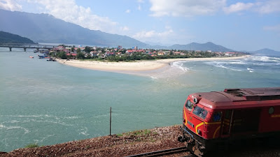A train passes by next to a small island enroute between Hoian and Hue, Vietnam