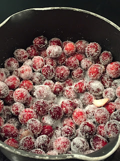 cranberries coated in sugar in a saucepan