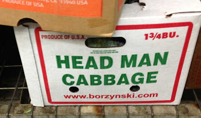 Produce box with green plain letters on the side that say HEAD MAN CABBAGE
