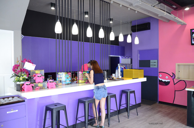 Brightly lit interior, with purple, pink and yellow being the bright colours used  