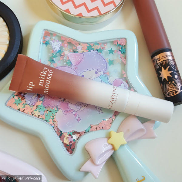 Clarins Lip Milky Mousse 06 Milky Nude tube of clarins milky mousse lip product in 06 milky nude on little twin stars star shaped mirror
