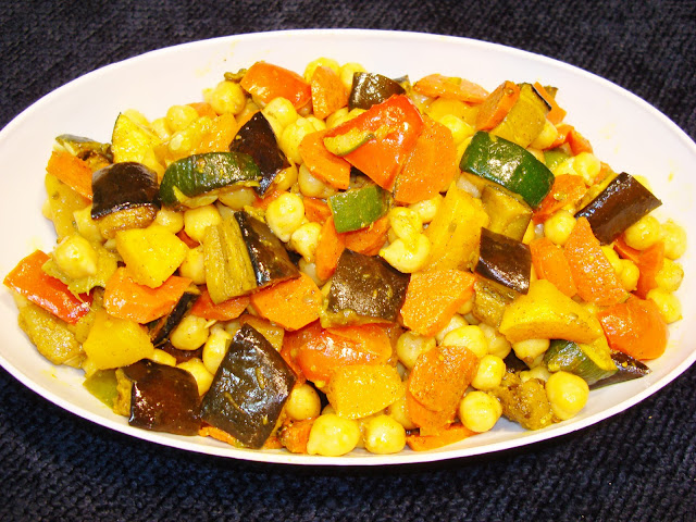 PORTIONS: 12 VEGETABLES INGREDIENTS 1 eggplant medium size, diced with skin on 4 carrots peeled and sliced thin 1 red pepper seeded and diced 1 small butternut squash peeled, seeded and diced 2 zucchini washed and sliced thick ½ tbsp. paprika 2 tbsp. olive oil 2 garlic cloves chopped fine 3/4 tbsp. salt 1 tsp. oregano leaves 1/4 tsp. ground black pepper VEGETABLES PREPARATION Preheat oven at 475° F Place the vegetables in a medium size sheet pan and add vegetable oil, garlic, salt, oregano leaves, black pepper. Cook the vegetables in the oven for 35 minutes. CHICK PEAS PREPARATION 1 lb. chickpeas, leave it soaking covered with water the night before. Drain the water and put the chickpeas in a cooking pot covered with fresh water and cook it with slow stove flame for about 45 minutes If you want to serve hot, once the chickpeas are cooked, drain the water, mix with the roasted vegetables and serve If you want to serve cold, let the roasted vegetables to cool. Drain the water off the chickpeas, let it cool, and mix with the roasted vegetables.