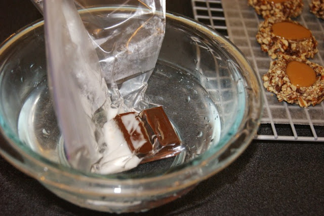 Insanely Delicious Turtle Cookies ... soft chocolate-pecan thumbprint cookies filled with caramel.  Yum! www.thekitchenismyplayground