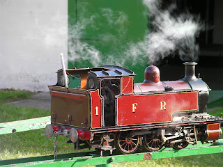 red miniature steam train broken down, narrowguage serial 1FR