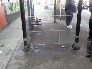 Poverty represented by litter at a bus stop in a Chicago hood